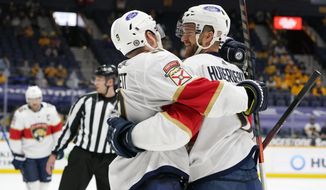 Florida Panthers left wing Jonathan Huberdeau, right, is congratulated by Sam Bennett (9) after Huberdeau scored a goal against the Nashville Predators in the third period of an NHL hockey game Tuesday, April 27, 2021, in Nashville, Tenn. (AP Photo/Mark Humphrey)