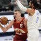 Denver Nuggets center Nikola Jokic, (15) drives to the rim as New Orleans Pelicans center Steven Adams defends in the first half of an NBA basketball game Wednesday, April 28, 2021, in Denver. (AP Photo/David Zalubowski)