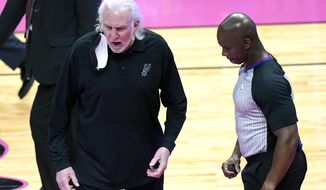 San Antonio Spurs coach Gregg Popovich, left, talks with official Dedric Taylor, right, during the first half of the team&#39;s NBA basketball game against the Miami Heat, Wednesday, April 28, 2021, in Miami. (AP Photo/Lynne Sladky)