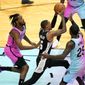 San Antonio Spurs guard Dejounte Murray (5) drives to the basket as Miami Heat forward Trevor Ariza, left, and guard Kendrick Nunn (25) defend during the second half of an NBA basketball game Wednesday, April 28, 2021, in Miami. (AP Photo/Lynne Sladky)