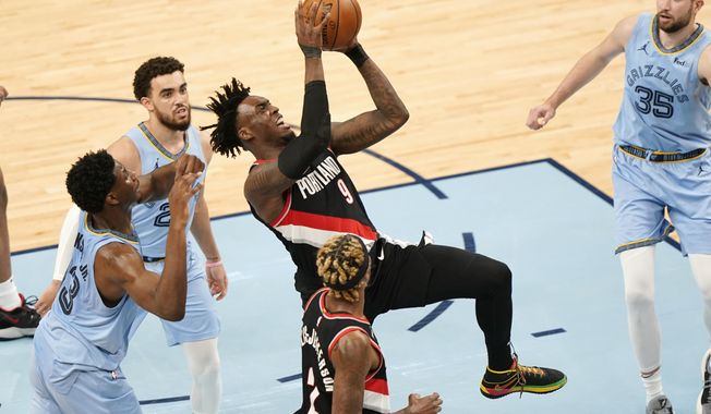 Portland Trail Blazers&#x27; Nassir Little (9) drives against Memphis Grizzlies defenders in the second half of an NBA basketball game Wednesday, April 28, 2021, in Memphis, Tenn. (AP Photo/Mark Humphrey)
