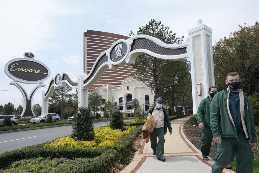 Workers depart a main gate to the Encore Boston Harbor casino, Wednesday, April 28, 2021, in Everett, Mass. The Encore Boston Harbor casino began offering COVID-19 vaccinations on Tuesday, April 27, by appointment only to employees and the general public in conjunction with Cambridge Health Alliance, a local health care organization. (AP Photo/Steven Senne)