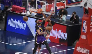 Washington Wizards forward Rui Hachimura (8) dunks against Los Angeles Lakers forward Anthony Davis (3) during the second half of an NBA basketball game, Wednesday, April 28, 2021, in Washington. (AP Photo/Nick Wass) **FILE**