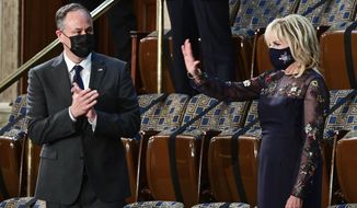 First lady Jill Biden waves as she arrives prior to President Joe Biden arriving to address a joint session of Congress, Wednesday, April 28, 2021, in the House Chamber at the U.S. Capitol in Washington, as Doug Emhoff looks on. (Jim Watson/Pool via AP)