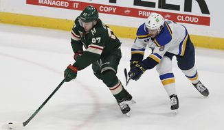 Minnesota Wild&#39;s Kirill Kaprizov (97) takes control of the puck next to St. Louis Blues&#39; Sammy Blais (9) during the first period of an NHL hockey game Thursday, April 29, 2021, in St. Paul, Minn. (AP Photo/Stacy Bengs)