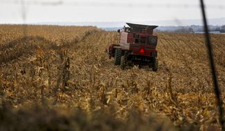 In this Dec. 4, 2017, file photo, a farmer harvests crops near Sinsinawa Mound in Wisconsin. A group of Midwestern farmers sued the federal government Thursday, April 29, 2021, alleging they can&#39;t participate in a COVID-19 loan forgiveness program because they&#39;re White. The group of plaintiffs includes farmers from Wisconsin, Minnesota, South Dakota and Ohio. According to the lawsuit, the Biden administration&#39;s COVID-19 stimulus plan provides $4 billion to forgive loans for socially disadvantaged farmers and ranchers who are Black, American Indian, Hispanic, Alaskan native, Asian American or Pacific Islander. (Eileen Meslar/Telegraph Herald via AP, File)