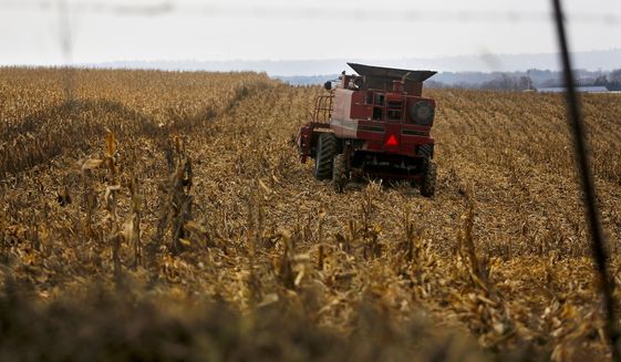 In this Dec. 4, 2017, file photo, a farmer harvests crops near Sinsinawa Mound in Wisconsin. A group of Midwestern farmers sued the federal government Thursday, April 29, 2021, alleging they can&#39;t participate in a COVID-19 loan forgiveness program because they&#39;re White. The group of plaintiffs includes farmers from Wisconsin, Minnesota, South Dakota and Ohio. According to the lawsuit, the Biden administration&#39;s COVID-19 stimulus plan provides $4 billion to forgive loans for socially disadvantaged farmers and ranchers who are Black, American Indian, Hispanic, Alaskan native, Asian American or Pacific Islander. (Eileen Meslar/Telegraph Herald via AP, File)
