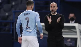 Manchester City&#39;s head coach Pep Guardiola, right, talks to Manchester City&#39;s Kyle Walker during the Champions League semifinal first leg soccer match between Paris Saint Germain and Manchester City at the Parc des Princes stadium, in Paris, France , Wednesday, April 28, 2021. (AP Photo/Thibault Camus)