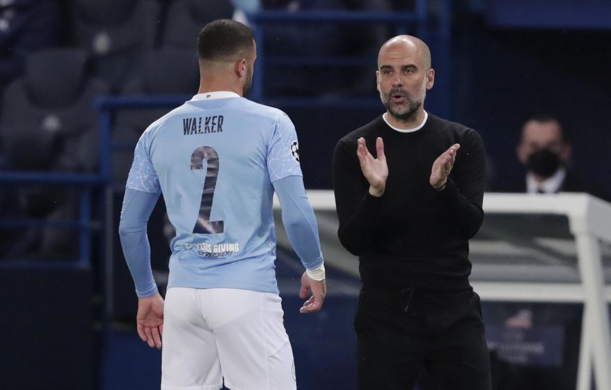 Manchester City&#39;s head coach Pep Guardiola, right, talks to Manchester City&#39;s Kyle Walker during the Champions League semifinal first leg soccer match between Paris Saint Germain and Manchester City at the Parc des Princes stadium, in Paris, France , Wednesday, April 28, 2021. (AP Photo/Thibault Camus)