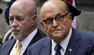 This photo from Friday Sept. 11, 2020, shows former New York Mayor Rudolph Giuliani, right, and former New York City Police Commissioner Bernard Kerik, left, during the Tunnel to Towers ceremony in New York. (AP Photo/Mark Lennihan, File)
