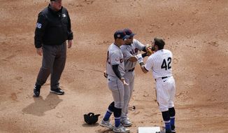 Cleveland Indians&#39; second baseman Cesar Hernandez, left, and Indians shortstop Andres Gimenez, center, argue with Chicago White Sox&#39;s Adam Eaton at second base during the first inning of a baseball game in Chicago, Thursday, April 15, 2021. (AP Photo/Nam Y. Huh)
