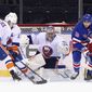 New York Islanders&#39; Semyon Varlamov (40) defends the net against New York Rangers&#39;Ryan Strome (16) during the first period of an NHL hockey game Thursday, April 29, 2021, in New York. (Bruce Bennett/Pool Photo via AP)