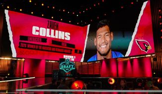 An image of Tulsa linebacker Zaven Collins is displayed on stage after he was chosen by the Arizona Cardinals with the 16 pick in the first round of the NFL football draft Thursday April 29, 2021, in Cleveland. (AP Photo/Tony Dejak)
