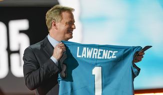 NFL Commissioner Roger Goodell holds a Jacksonville Jaguars jersey as he announces that the Jaguars had chosen Clemson quarterback Trevor Lawrence with the first pick in the NFL football draft, Thursday April 29, 2021, in Cleveland. (AP Photo/Tony Dejak)