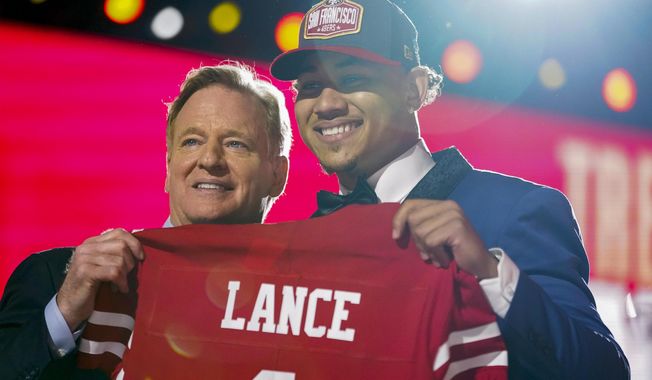 North Dakota State quarterback Trey Lance, right, holds a jersey with NFL Commissioner Roger Goodell after being chosen by the San Francisco 49ers with the third pick in the first round of the NFL football draft Thursday April 29, 2021, in Cleveland. (AP Photo/Tony Dejak)