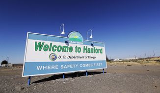 FILE - In this Aug. 13, 2019, file photo, a sign at the Hanford Nuclear Reservation is posted near Richland, Wash. Officials say an underground nuclear waste storage tank that dates to World War II appears to be leaking contaminated liquid into the ground. The U.S. Department of Energy said Thursday, April 29, 2021, that Tank B-109 holds 123,000 gallons of radioactive waste left from the production of plutonium for nuclear weapons on the Hanford Nuclear Reservation. (AP Photo/Elaine Thompson, File)