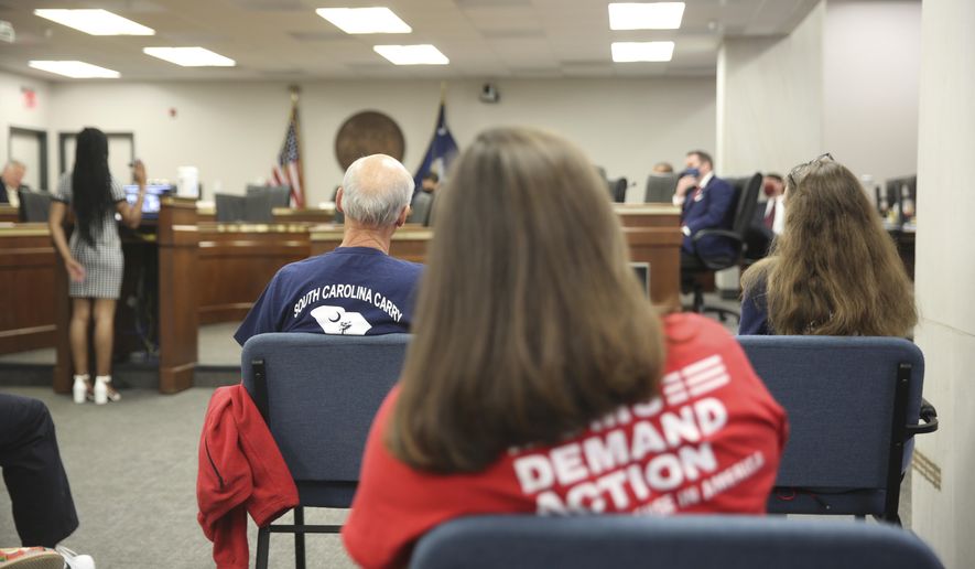 People listen to a Senate subcommittee hearing about a bill that would allow people who already have concealed weapons permits to carry their guns in the open on Tuesday, April 27, 2021, in Columbia, S.C. The bill doesn't appear to have time to pass this session. (AP Photo/Jeffrey Collins)