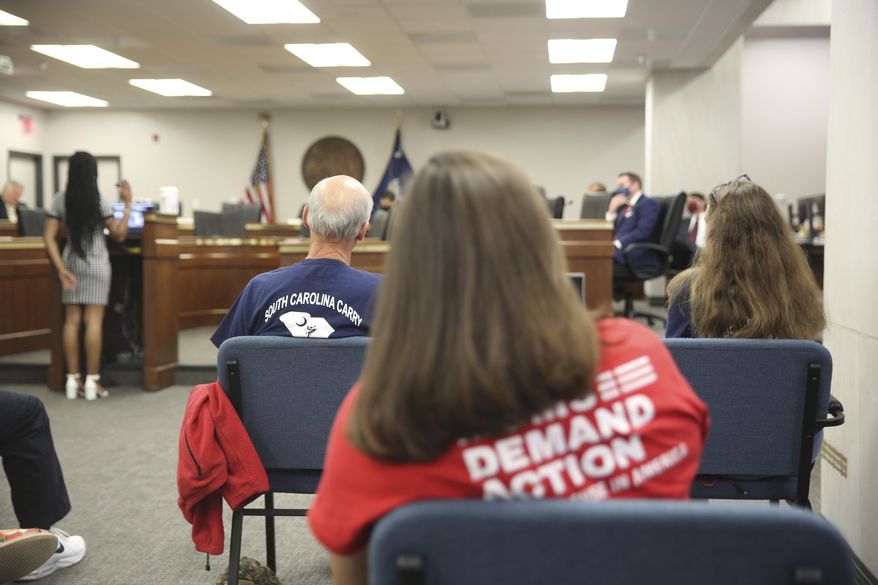 People listen to a Senate subcommittee hearing about a bill that would allow people who already have concealed weapons permits to carry their guns in the open on Tuesday, April 27, 2021, in Columbia, S.C. The bill doesn't appear to have time to pass this session. (AP Photo/Jeffrey Collins)