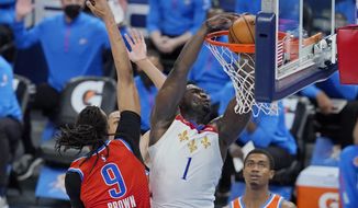 New Orleans Pelicans forward Zion Williamson (1) dunks next to Oklahoma City Thunder center Moses Brown (9) during the second half of an NBA basketball game Thursday, April 29, 2021, in Oklahoma City. (AP Photo/Sue Ogrocki)