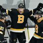Boston Bruins center Charlie Coyle celebrates his goal against the Buffalo Sabres with left wing Nick Ritchie (21) and center Sean Kuraly (52) during the third period of an NHL hockey game Thursday, April 29, 2021, in Boston. (AP Photo/Elise Amendola)