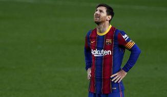 Barcelona&#39;s Lionel Messi reacts after a missed scoring opportunity during the Spanish La Liga soccer match between FC Barcelona and Granada at the Camp Nou stadium in Barcelona, Spain, Thursday, April 29, 2021. (AP Photo/Joan Monfort)
