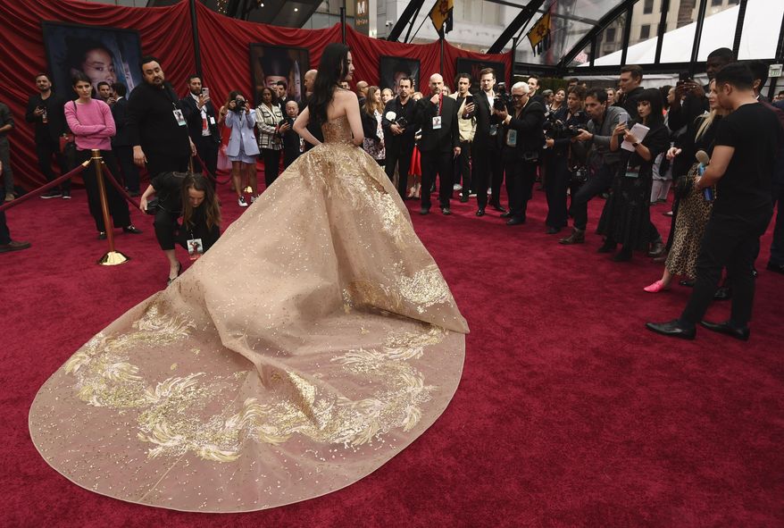 Yifei Liu, star of the new live-action "Mulan," poses for photographers at the premiere of the film at the El Capitan Theatre, Monday, March 9, 2020, in Los Angeles. (AP Photo/Chris Pizzello)
