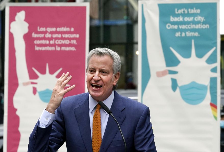 In this Monday, April 12, 2021, file photo, New York Mayor Bill de Blasio delivers remarks in Times Square after he toured the grand opening of a Broadway COVID-19 vaccination site intended to jump-start the city&#x27;s entertainment industry, in New York. (AP Photo/Richard Drew) ** FILE **