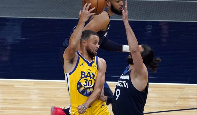 Golden State Warriors&#x27; Stephen Curry (30) passes the ball as Minnesota Timberwolves&#x27; Ricky Rubio (9) defends in the first half of an NBA basketball game, Thursday, April 29, 2021, in Minneapolis. (AP Photo/Jim Mone)