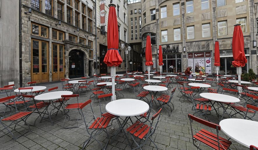 FILE - In this March 18, 2021 file photo, empty tables are seen on a deserted square in normally very busy old town of Cologne, Germany, Thursday. The European Union statistics agency Eurostat announces first-quarter growth figures for the 19 countries that use the euro. (AP Photo/Martin Meissner)