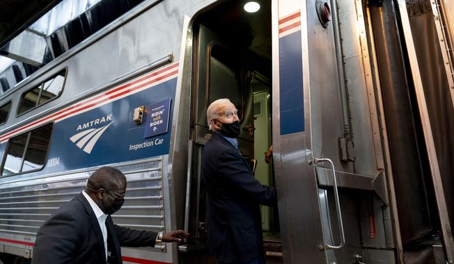 FILE - In this Sept. 30, 2020, file photo, then-Democratic presidential candidate former Vice President Joe Biden boards his train at Amtrak&#x27;s Pittsburgh Train Station in Pittsburgh. President Joe Biden is set to help the nation&#x27;s passenger rail system celebrate 50 years of service. (AP Photo/Andrew Harnik)