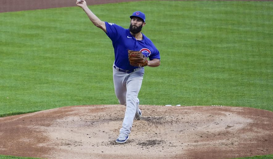 Chicago Cubs starting pitcher Jake Arrieta throws during the first inning of the team's baseball game against the Cincinnati Reds on Friday, April 30, 2021, in Cincinnati. (AP Photo/Jeff Dean)