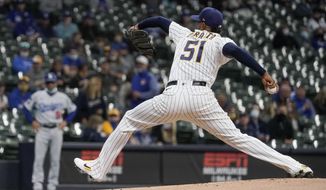 Milwaukee Brewers starting pitcher Freddy Peralta throws during the first inning of a baseball game against the Los Angeles Dodgers Friday, April 30, 2021, in Milwaukee. (AP Photo/Morry Gash)
