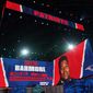 Images are displayed on stage of Christian Barmore, defensive tackle at Alabama, selected by the New England Patriots in the second round of the NFL football draft, Friday, April 30, 2021, in Cleveland. (AP Photo/Tony Dejak)