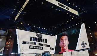 An image of Houston defensive end Payton Turner is displayed on stage after he was chosen by the New Orleans Saints with the 28th pick in the first round of the NFL football draft Thursday April 29, 2021, in Cleveland. (AP Photo/Tony Dejak)