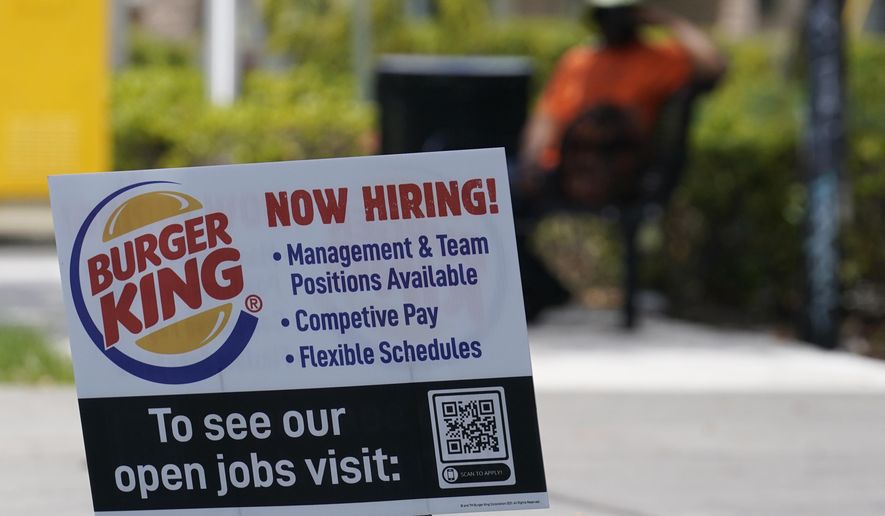 A sign looking for employees to work at Burger King restaurants is posted, Tuesday, April 27, 2021, in Miami.  Restaurant Brands International, the parent company of Burger King, saw its sales climb in the first quarter to top Wall Street’s view as Americans made purchases at the burger chain amid easing coronavirus pandemic restrictions.  (AP Photo/Marta Lavandier)