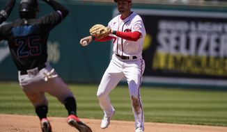 Washington Nationals shortstop Trea Turner (7) forces the out on Miami Marlins&#39; Lewis Brinson at second before throwing to first base for a double play during the fourth inning of a baseball game at Nationals Park, Saturday, May 1, 2021, in Washington. (AP Photo/Alex Brandon)