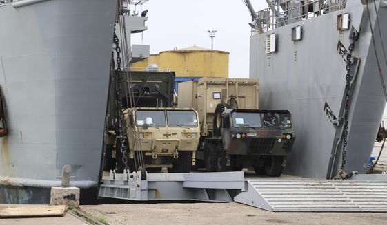 U.S. Army vehicles disembark from a vessel at Albania's main port of Durres, Saturday, May 1, 2021. Florida National Guard's 53rd Infantry Brigade Combat Team were being discharged from the USNS Bob Hope ahead of a two-week training of up to 6,000 U.S. troops in six Albanian military bases, as part of the Defender-Europe 21 large-scale U.S. Army-led exercise. (AP Photo/Hektor Pustina)