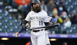 Colorado Rockies&#39; Charlie Blackmon heads back to the dugout after striking out against Houston Astros starting pitcher Luis Garcia during the second inning of a baseball game Tuesday, April 20, 2021, in Denver. (AP Photo/David Zalubowski)