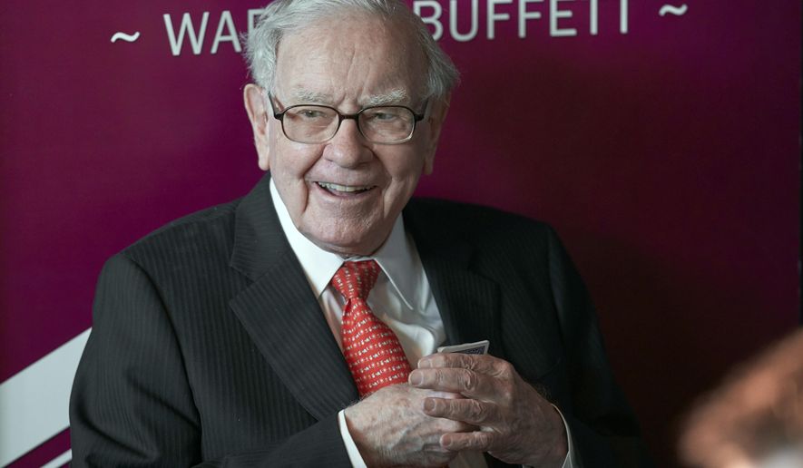 FILE - In this May 5, 2019, file photo Warren Buffett, Chairman and CEO of Berkshire Hathaway, smiles as he plays bridge following the annual Berkshire Hathaway shareholders meeting in Omaha, Neb.  Buffett will spend Saturday afternoon fielding questions at Berkshire Hathaway&#39;s annual meeting, which is being held virtually.  (AP Photo/Nati Harnik, File)
