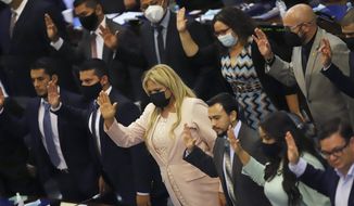 New members of the New Ideas party are sworn in during the Legislative Assembly in San Salvador, El Salvador, Saturday, May 1, 2021. (AP Photo/Salvador Melendez)