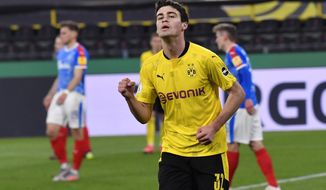 Dortmund&#39;s Giovanni Reyna celebrates after scoring his side&#39;s second goal during the German Soccer Cup semifinal match between Borussia Dortmund and Holstein Kiel in Dortmund, Germany, Saturday, May 1, 2021. (AP Photo/Martin Meissner, Pool)
