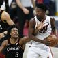 Miami Heat&#39;s Jimmy Butler (22) grabs a rebound against Cleveland Cavaliers&#39; Collin Sexton (2) during the second half of an NBA basketball game, Saturday, May 1, 2021, in Cleveland. (AP Photo/Ron Schwane)