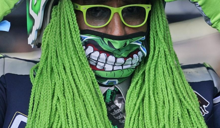 Seattle Seahawks fan Wallace Watts watches the fourth round of the NFL football draft, Saturday, May 1, 2021, in Cleveland. (AP Photo/Tony Dejak)