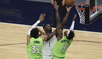 New Orleans Pelicans&#39; Zion Williamson (1) shoots against Minnesota Timberwolves&#39; Karl-Anthony Towns (32) and Jarred Vanderbilt (8) during the first half of an NBA basketball game Saturday, May 1, 2021, in Minneapolis. (AP Photo/Stacy Bengs)