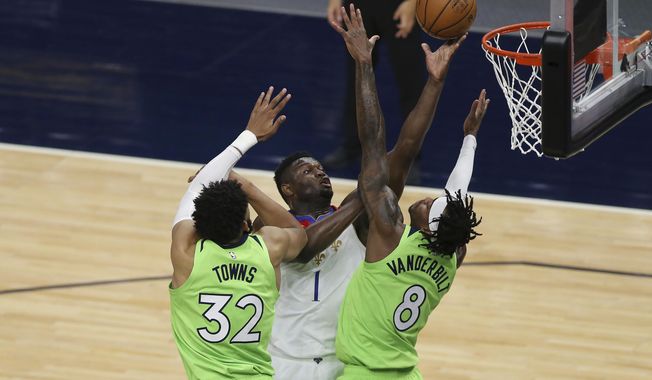 New Orleans Pelicans&#x27; Zion Williamson (1) shoots against Minnesota Timberwolves&#x27; Karl-Anthony Towns (32) and Jarred Vanderbilt (8) during the first half of an NBA basketball game Saturday, May 1, 2021, in Minneapolis. (AP Photo/Stacy Bengs)