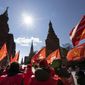 Communists party supporters gather with red flags to mark Labour Day, also knows as May Day near Red Square in Moscow, Russia, Saturday, May 1, 2021. (AP Photo/Alexander Zemlianichenko)