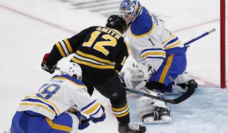 Boston Bruins&#39; Craig Smith (12) scores on Buffalo Sabres&#39; Ukko-Pekka Luukkonen (1) during the first period of an NHL hockey game, Saturday, May 1, 2021, in Boston. (AP Photo/Michael Dwyer)