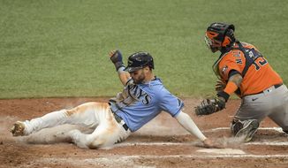 Tampa Bay Rays&#x27; Kevin Kiermaier, left, slides past Houston Astros catcher Martin Maldonado, right, to score on Rays&#x27; Willy Adames&#x27; ground ball to first during the sixth inning of a baseball game Sunday, May 2, 2021, in St. Petersburg, Fla. (AP Photo/Steve Nesius)