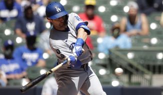 Los Angeles Dodgers&#39; AJ Pollock hits a grand slam during the first inning of a baseball game against the Milwaukee Brewers Sunday, May 2, 2021, in Milwaukee. (AP Photo/Aaron Gash)
