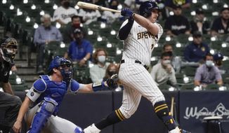 Milwaukee Brewers&#39; Travis Shaw hits the game-winning RBI single during the 11th inning of a baseball game against the Los Angeles Dodgers Saturday, May 1, 2021, in Milwaukee. The Brewers won 6-5. (AP Photo/Morry Gash)